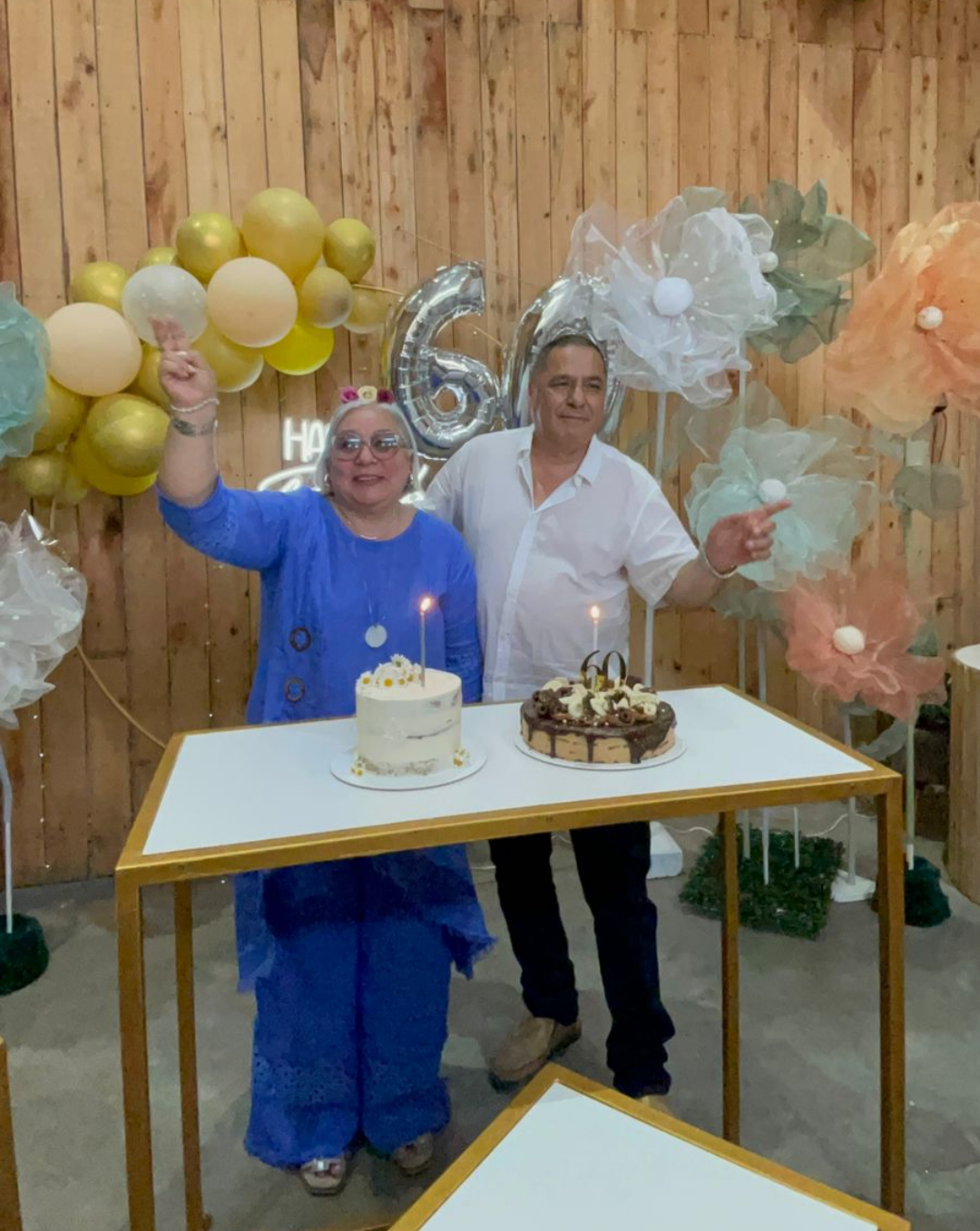 Grupo de amigos y novios celebrando con tiras de fotos impresas y cotillón en fotocabina de boda